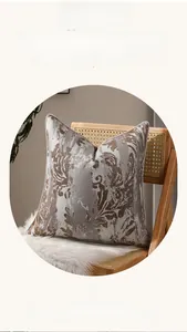 Gros plan d'une housse de coussin en jacquard avec motifs abstraits marron et blanc