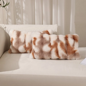 Set of two rectangular brown and white faux rabbit fur plush pillow covers on sofa