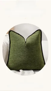 Detailed close-up of grass green chenille pillow cover with diagonal texture and black trim