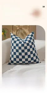 Detail view of the soft chenille fabric texture on a blue and white checkered cushion cover