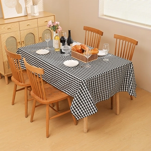 Classic black and white checkered tablecloth on a wooden rectangular dining table