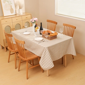 Modern minimalist brown checkered waterproof tablecloth with natural linen texture on wood table