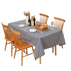 Modern navy and white checkered waterproof tablecloth on wooden table with dining props