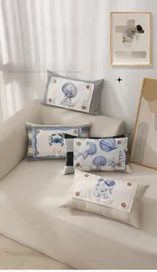 Detailed view of marine themed cushion covers with wooden buttons and shell patterns