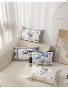 Detail of nautical lumbar pillows with ocean patterns and vintage wooden button accents