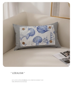 Detail of nautical lumbar pillow featuring shell print and wooden buttons on stripes