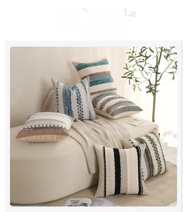 Close-up of bohemian tufted pillow covers with colorful textured embroidery and soft tassels