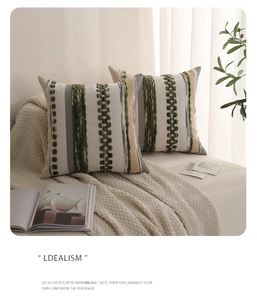 Detail of tufted colorful woven pillow covers on sofa featuring textured stripes