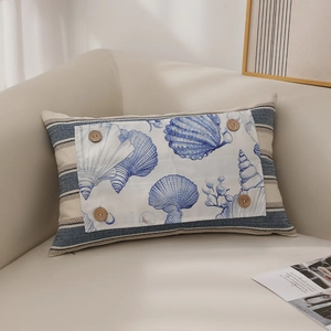 Nautical sea shell lumbar pillow with blue stripes and wooden buttons on beige sofa
