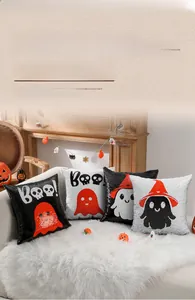 Close-up of reversible sequin Halloween pillows with ghost and skull designs on sofa