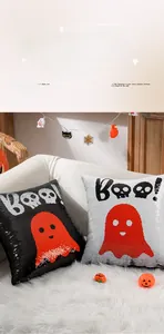Detail of Halloween sequin pillow showing reversible red ghost pattern and Boo text