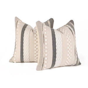 Bohemian woven tufted throw pillow covers in cream and charcoal grey for sofa decor