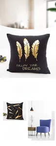 Detail of black velvet pillowcase featuring gold foil feathers and follow your dreams text