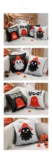 Detail of Halloween sequin pillow showing spooky ghost and Boo! designs on sofa
