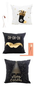 Detail of Christmas pillow covers featuring gold stamped socks, trees and festive lettering
