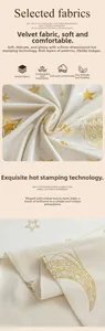 Detailed view of velvet tablecloth featuring gold star and moon foil stamping texture