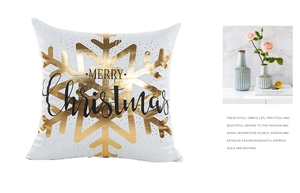 Detail of white Christmas pillow cover with gold foil snowflake and Merry Christmas text