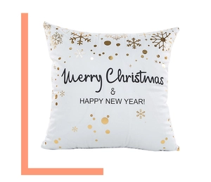 Close-up of white Christmas pillowcase with gold snowflakes and black festive text