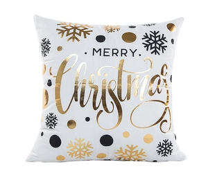 Detail of gold foiled MERRY Christmas lettering and snowflakes on white pillowcase