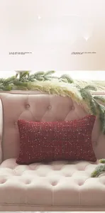 Macro shot of red tweed rectangular pillow cover with thick knit texture on velvet sofa
