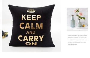 Detail of black pillowcase featuring gold foil Keep Calm text and crown motif