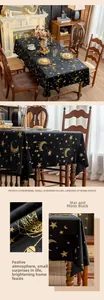 Detail of black velvet tablecloth with metallic gold star and moon pattern texture