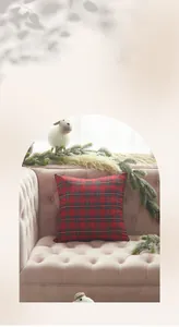 Red and black plaid knitted cotton pillow cover placed on a velvet sofa with pine decor