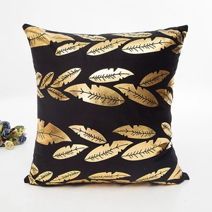 Modern black throw pillow case with golden leaf pattern and velvet texture for home decor