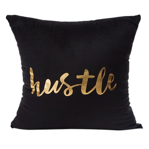 Modern black velvet pillowcase with metallic gold 'hustle' script print on white background