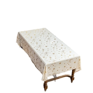 Star and moon gold foil rectangle tablecloth on a wooden table with celestial patterns