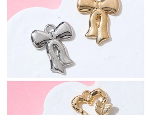 Details von Metallschleifen und Herz-Schmetterling-Anhängern für DIY-Schmuckzubehör