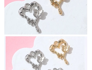 Makro-Detail von flüssigen Herzanhängern mit Schmetterlingsmotiven in Silber und Gold