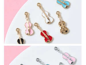 Detailed close-up of colorful enamel violin charms with gold and silver metal bases
