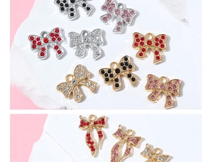 Close-up of sparkling rhinestone bow pendants in silver and gold for DIY jewelry making