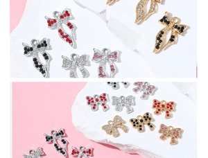 Macro detail of rhinestone-studded bow charms in gold and silver finish for DIY jewelry