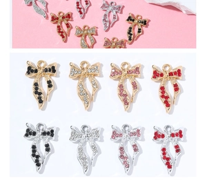 Detail of colorful bow-shaped charms with rhinestones and loop for DIY jewelry making