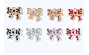 Detail view of sparkling rhinestone bow pendants for DIY jewelry and bag accessories