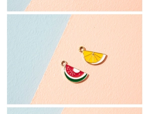 Detailed view of colorful watermelon and lemon enamel alloy pendants with golden loops