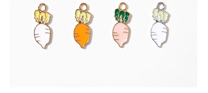 Detail of four colorful carrot alloy pendants with enamel coating for DIY jewelry