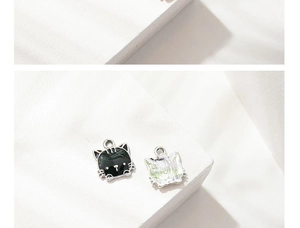 Detailed view showing the front and back of an enamel cat charm for DIY jewelry