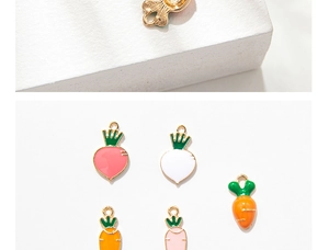 Detailed macro view of colorful alloy carrot charms with polished golden backings