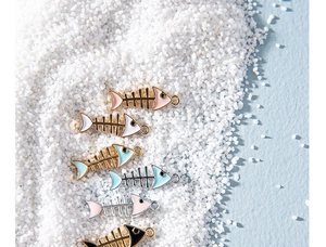 Macro detail of colorful fish bone alloy charms in various oil-drip colors for DIY jewelry