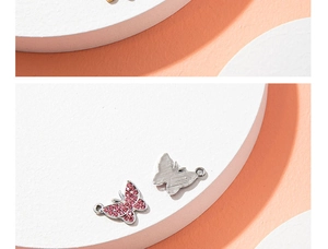 Macro view of pink rhinestone butterfly pendants for DIY jewelry making