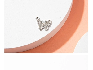Detailed close-up of a silver butterfly pendant encrusted with clear zircon crystals
