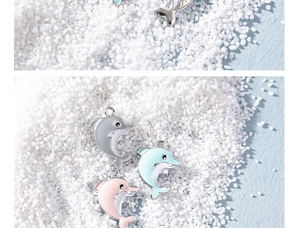 Detailed view of colorful enamel dolphin charms for DIY jewelry and keychains