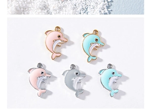 Detail of colorful enamel dolphin pendants with gold and silver alloy finish for DIY charms