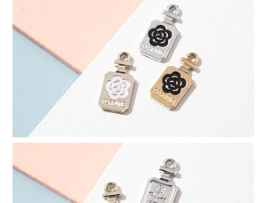 Detailed macro of enamel perfume bottle charms with camellia flower pattern
