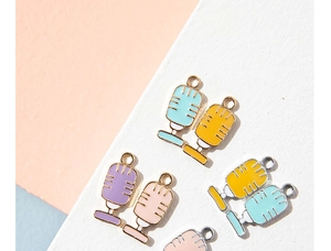 Detailed view of colorful enamel microphone charms in light blue and yellow for DIY jewelry