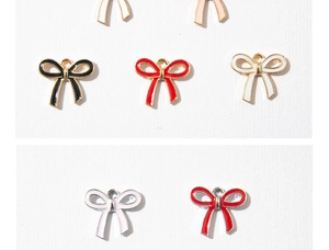 Detailed view of colorful enamel bow charms with golden alloy edges for DIY jewelry making