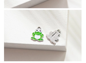 Macro view showing the front and back of a green frog alloy pendant with enamel finish